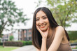 © Chanakon - Happy feeling of Beautiful Young Woman smiling outdoor in sunlight. Pretty attractive face of female and beautiful smile. She is positive thinking and successful.