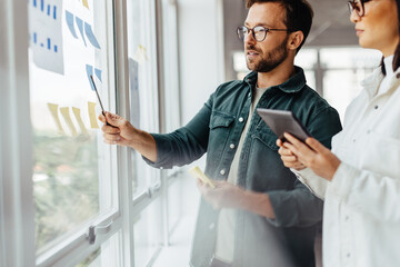 Poster - Creative business people brainstorming with sticky notes in an office