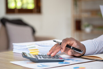 Wall Mural - African black businessman sitting doing a financial report and studying annual profit analysis An accountant checking the financial status of the company is in the office.