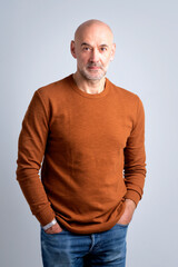 Portrait of a confident mature man with bald head against isolated background