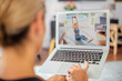 © gzorgz - Rear view of a woman using laptop for online training at home