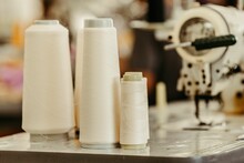 Spools Of White Thread And Sewing Machines