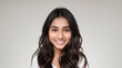 © Dawid - Portrait of Indian smiling teenager girl on grey and beige isolated empty background. Copy space. Generative AI