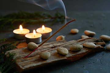 An incense stick that burns and generates smoke.