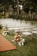 Vertical shot of an outdoor seating arrangement in a garden with floral decorations for a wedding