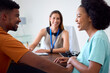 © Monkey Business - Pregnant Couple At Appointment With Female Doctor Or GP In Office