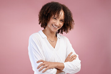 Canvas Print - Full of confidence. Cropped portrait of an attractive young woman standing with her arms folded in studio against a pink background.