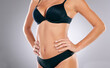 © Nicholas Felix/peopleimages.com - Body confidence. an unrecognizable young woman posing in her underwear against a grey background in studio.