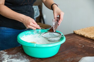 Sticker - Housewife in process of baking delicious a cake in the kitchen - adding cacao to the cream