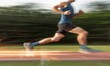 © Shanti - a blurry photo of a man running on a track with trees in the backgrouds in the background and a blurry image of a man running on the ground.  generative ai