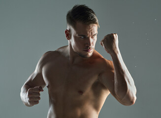 Sticker - Tap into your inner strength. a young man practicing his punches against a studio background.