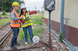 © reewungjunerr - Two engineer working at train station,Work together happily,Help each other analyze the problem,Consult about development guidelines