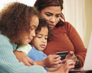 Sticker - Choosing outfits for the girls. an attractive young woman sitting with her daughters at home and using a laptop for online shopping.