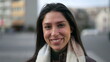 © Marco - One happy young woman walks confidently in street sidewalk smiling. Closeup face of a joyful adult girl walking in urban environment