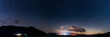 A panoramic night view of the night sky looking over Bassenthwaite lake in the English Lake District.