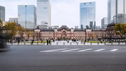 Wall Mural - Timelapse of car traffic transportation on road, Japanese people, traveler walk at Tokyo Station building in Tokyo. Japan train transport, Asia travel tourism landmark, Asian city life concept