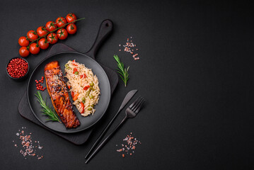 Delicious red salmon fish grilled with sauce and sesame seeds with rice and vegetables