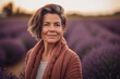 © Robert MEYNER - Portrait of mature woman standing in lavender field at sunset.