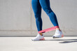 © Kaspars Grinvalds - Woman exercising lateral leg lifts with resistance band