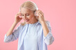 © Pixel-Shot - Mature woman in headphones on pink background