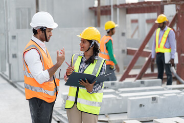 Wall Mural - India engineer woman and Asia engineer man working with document at precast site work	