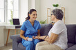 © Studio Romantic - Smiling nurse measuring pressure of positive elderly woman. Caregiver visiting senior woman at home. Friendly nurse and patient talking during health check up. Caregiving, nursing of elderly people