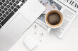 Cup of coffee with earphones, newspaper and laptop on white wooden background