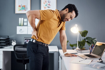 Poster - Night, back pain and business man with stress at office desk in a modern workplace. Professional asian male person with health, body ache or burnout problem while tired, injured and working late