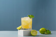 Glass of lime lemonade. Summer refreshing lemonade drink or alcoholic cocktail with ice, mint, lime and orange juice.