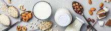 Vegan Milk And Ingredients On Rustic Background, Flat Lay