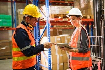 Group of Industrial workers working at a warehouse factory.