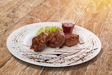 Wall Mural - Roasted tasty meat sliced on plate with herbs and spices