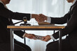 © Phimwilai - business people shaking hands and Give an under-the-table bribe to an attorney to help a lawyer win a court case. Bribery and Kickback Ideas Fraud and Fraud