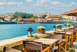 Fototapeta  - View of open-air street cafe on the banks of the River Douro in Porto, Portugal