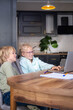 © FOTO_STOCKER - Online school class, siblings pupils boy and girl learning together remotely online at home, looking to laptop, speaking with teacher or tutor using internet