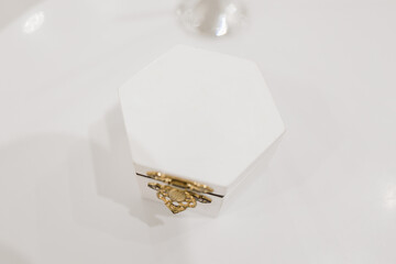 Poster - white wooden box for wedding rings on the table