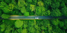Aerial View Asphalt Road And Green Forest, Forest Road Going Through Forest With Car Adventure View From Above, Ecosystem And Ecology Healthy Environment Concepts And Background.