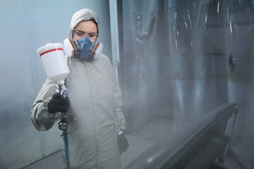 Wall Mural - Automobile repairwoman servicing car in painting booth