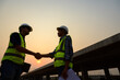 © เลิศลักษณ์ ทิพชัย - Highway engineering with architect shake hands teamwork talking and blank sheet good teamwork Engineer working on motorway bridge and concrete road at construction site