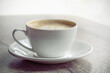 © oleh11 - Cup of hot cappuccino coffee on table