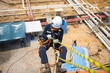 © chitsanupong - Closeup male worker standing on tank male worker height roof tank knot carabiner rope access safety