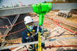 © chitsanupong - Closeup male worker standing on tank male worker height roof tank knot carabiner rope access safety