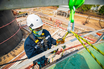 Closeup male worker standing on tank male worker height roof tank knot carabiner rope access safety