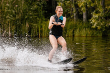 Beautiful Young Woman Water Skiing Behind Motorboat On Lake, Extreme Water Sports, Summer Vacation