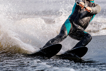 close-up man athlete riding waterskiing on lake, extreme summer water sports