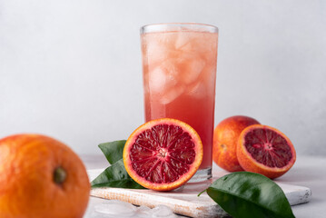 Wall Mural - Juice or cocktail of red Sicilian oranges with ice cubes in a glass