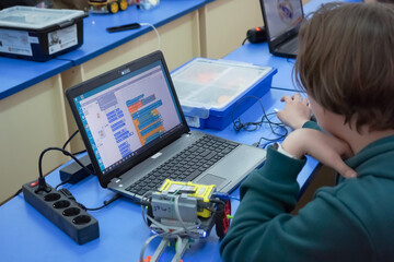 children build and program construction robots at a robotics lesson at school. education, children, 