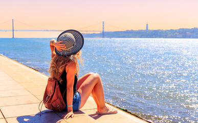 Wall Mural - Woman traveler looking at famous bridge in Lisbon- Portugal, Europa