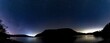 A panoramic view of the night sky over Ullswater in the English Lake District.