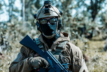 Anonymous soldier with AK-47 in the middle of the battlefield